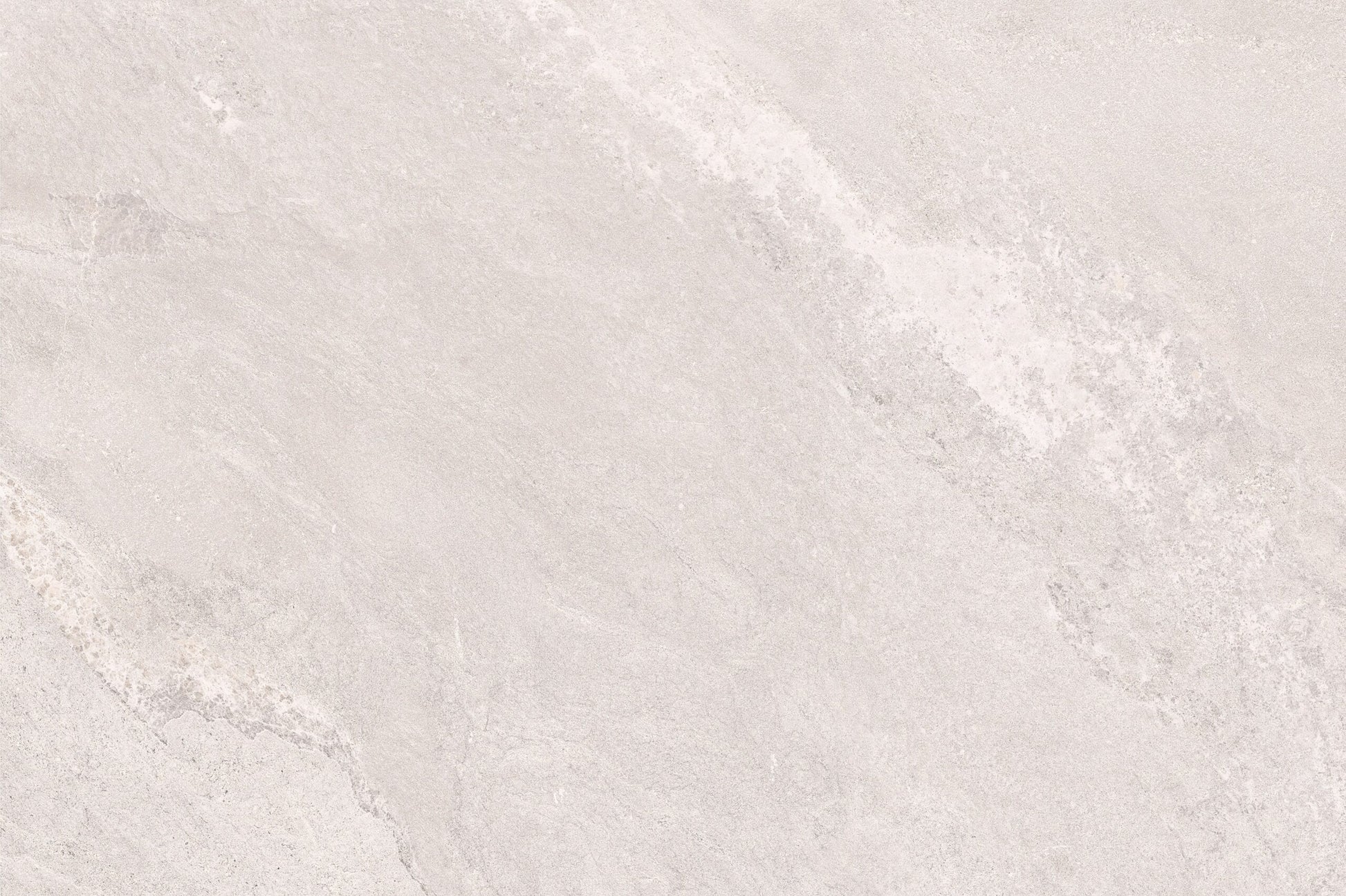 Light gray stone surface with subtle, natural veining and texture. The pattern is soft and organic, making Antigua White Porcelain Paving Slabs ideal for a smooth, neutral background in outdoor porcelain tiles or modern spaces.