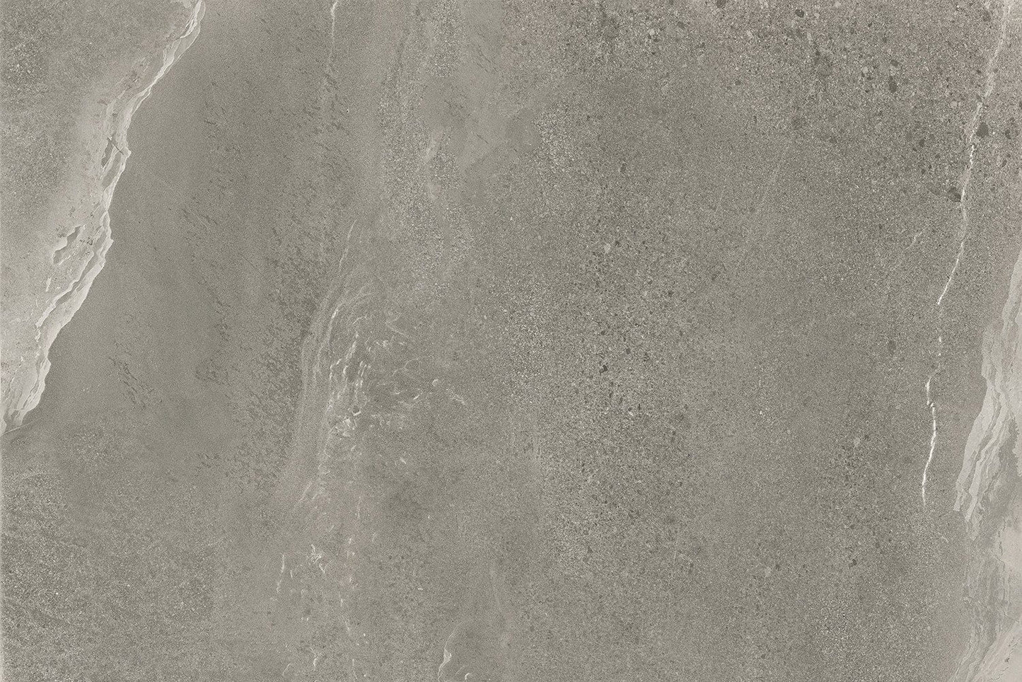 Gray stone surface with subtle variations in texture and color, featuring wavy, natural patterns and fine speckling throughout. Ideal for grey outdoor tiles or porcelain paving, this finish offers the look of polished marble with slip resistant qualities.
