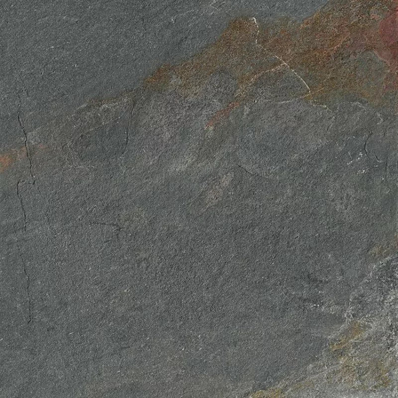 Close-up of a textured dark gray stone surface, ideal for porcelain paving or garden paths, with natural roughness, fine cracks, and subtle streaks of brown and reddish hues blending into the background.