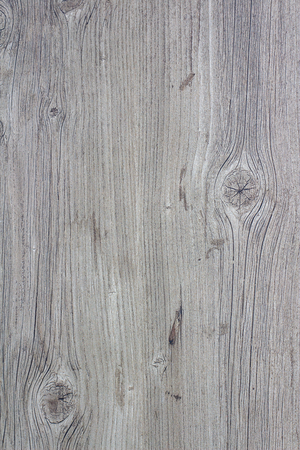 Close-up of a wooden surface featuring a light brown color with visible grain patterns and knots, similar to the texture found in wood look porcelain tile. The natural lines and imperfections add realistic depth and character.