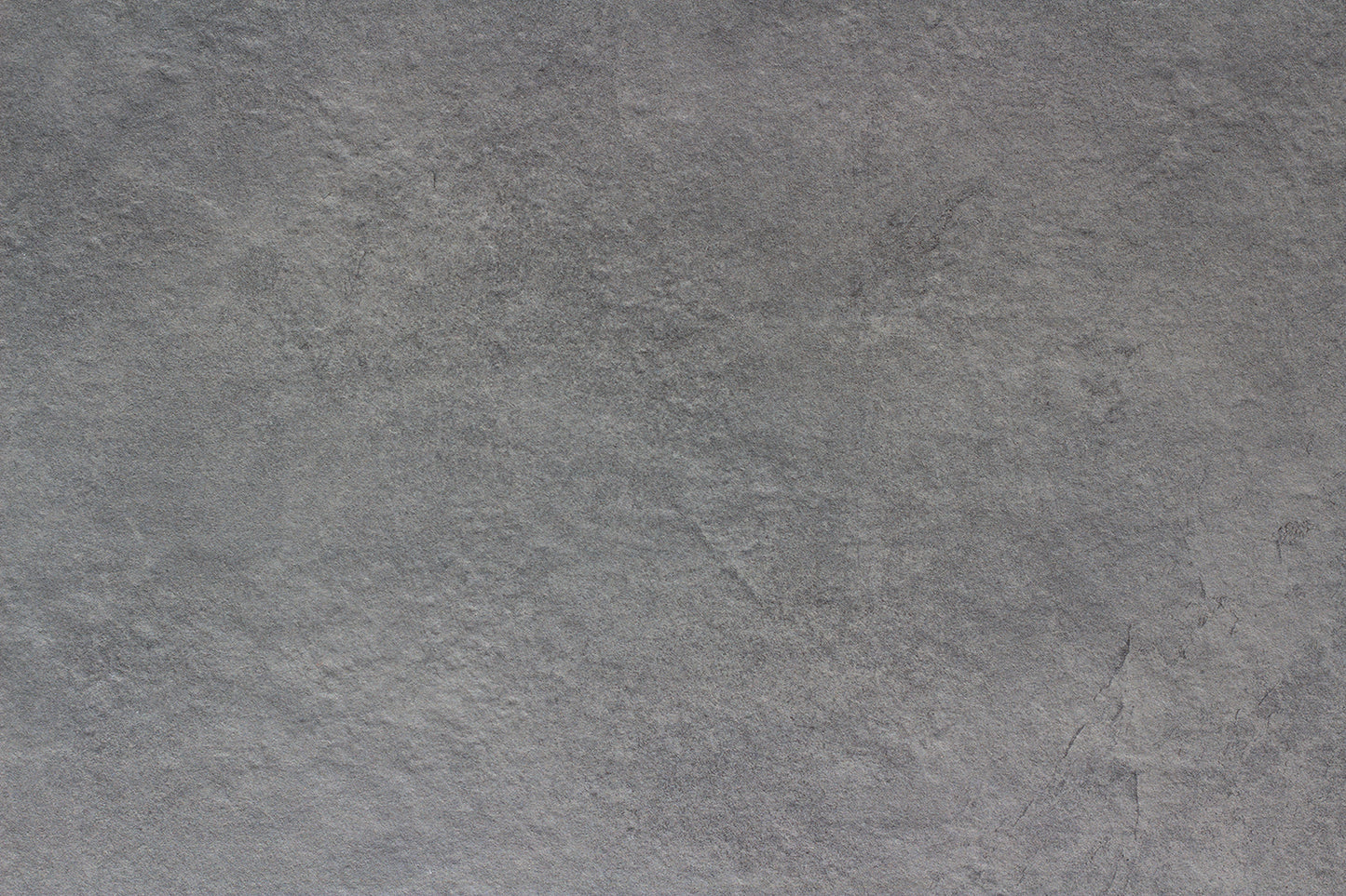 Rough, gray stone surface with subtle texture and natural variegation; appears slightly uneven and has a muted, matte finish—ideal as a slip-resistant tile for outdoor porcelain tile applications.