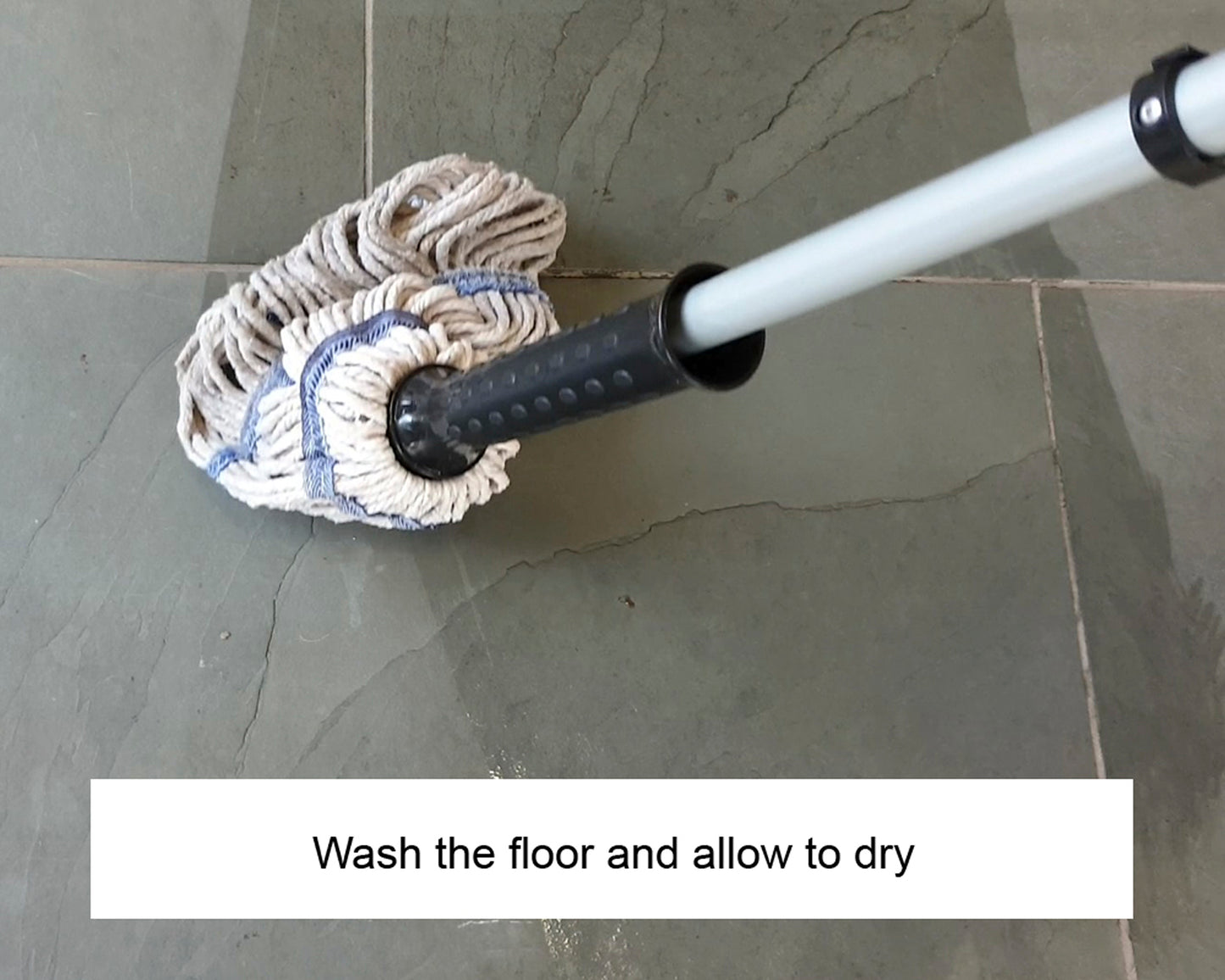 A mop cleaning a tiled floor, with a visibly wet section, and the text "Wash the floor with stone surface cleaner and allow to dry" displayed at the bottom.