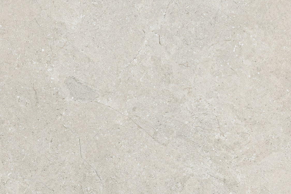 Light gray marble surface with subtle white and darker gray veining, this smooth texture mirrors the elegance of Lindeman Marfil Porcelain tiles—ideal for sleek countertops or as outdoor porcelain tiles with a natural stone look.
