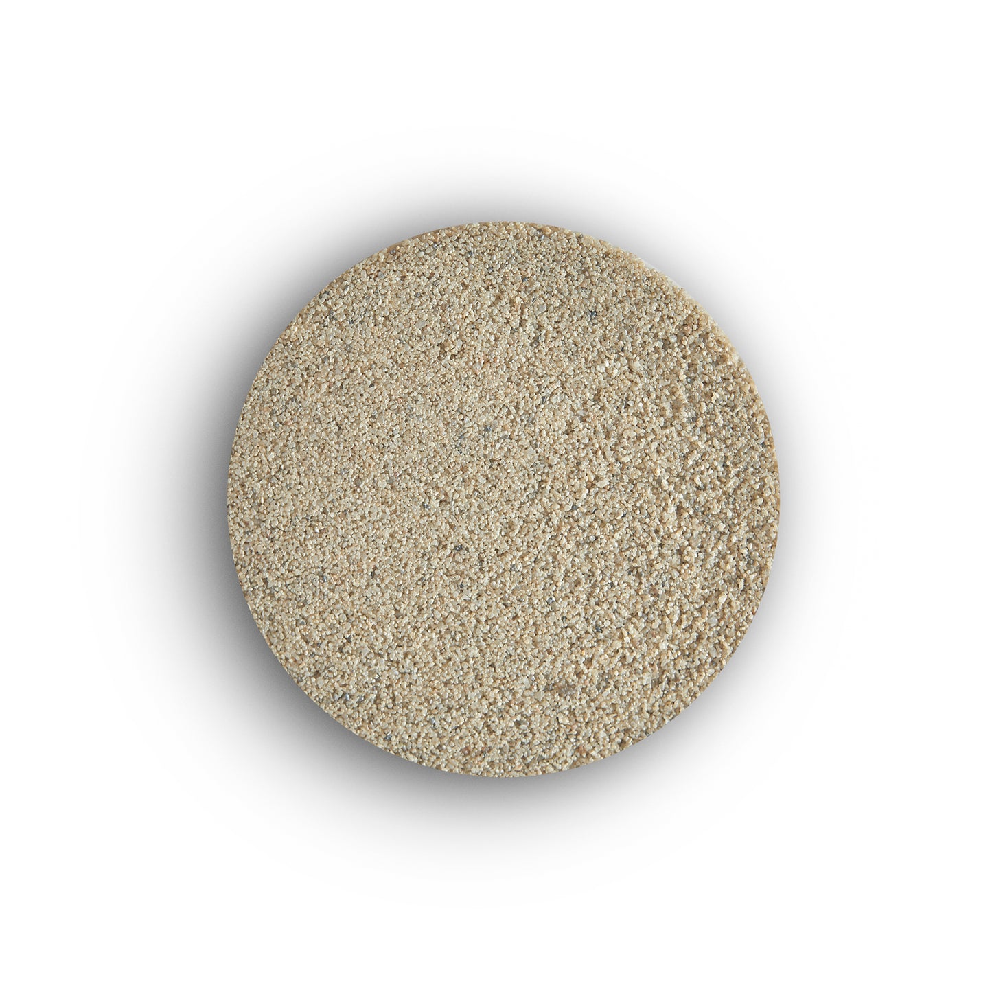 A round pile of light beige, granular instant dry yeast viewed from above on a white background, resembling the fine texture of porcelain tile grout.