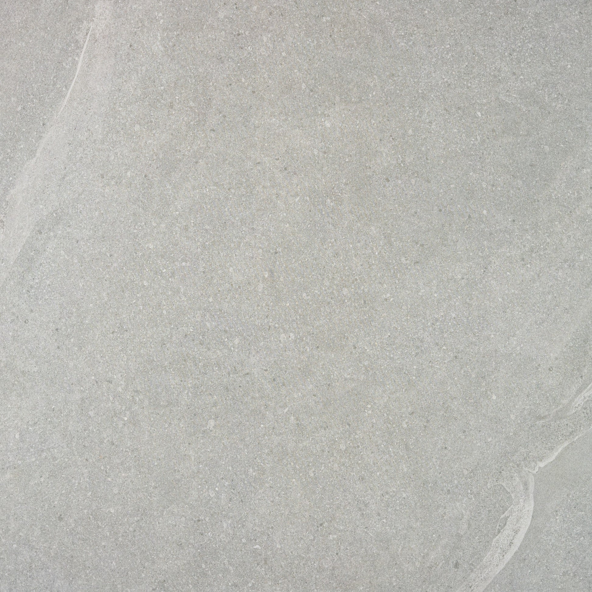 Light gray Ashmore Grey Porcelain Slabs feature subtle, natural veining and a slightly textured appearance. Their uniform, smooth pattern makes these outdoor porcelain tiles ideal for stylish, slip-resistant paving slabs in modern spaces.