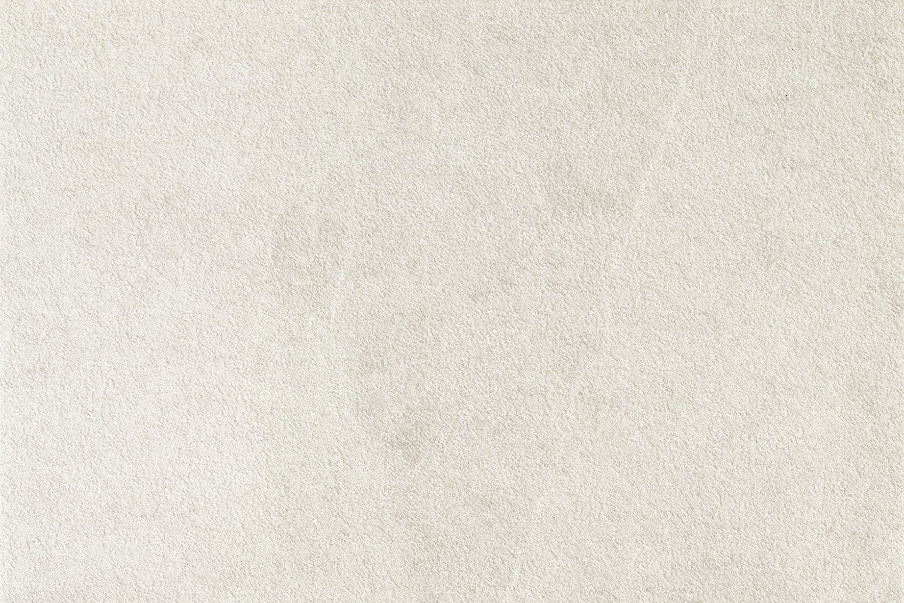 Close-up of a light beige textured surface, resembling suede or soft leather, with subtle variations in color and a slightly mottled appearance—perfect inspiration for designing porcelain paving or elegant outdoor pavers.