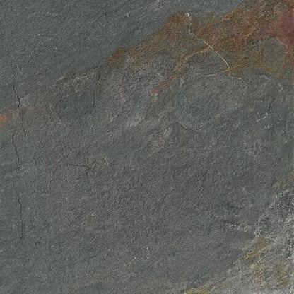 Close-up of a textured dark gray stone surface, ideal for porcelain paving or garden paths, with natural roughness, fine cracks, and subtle streaks of brown and reddish hues blending into the background.