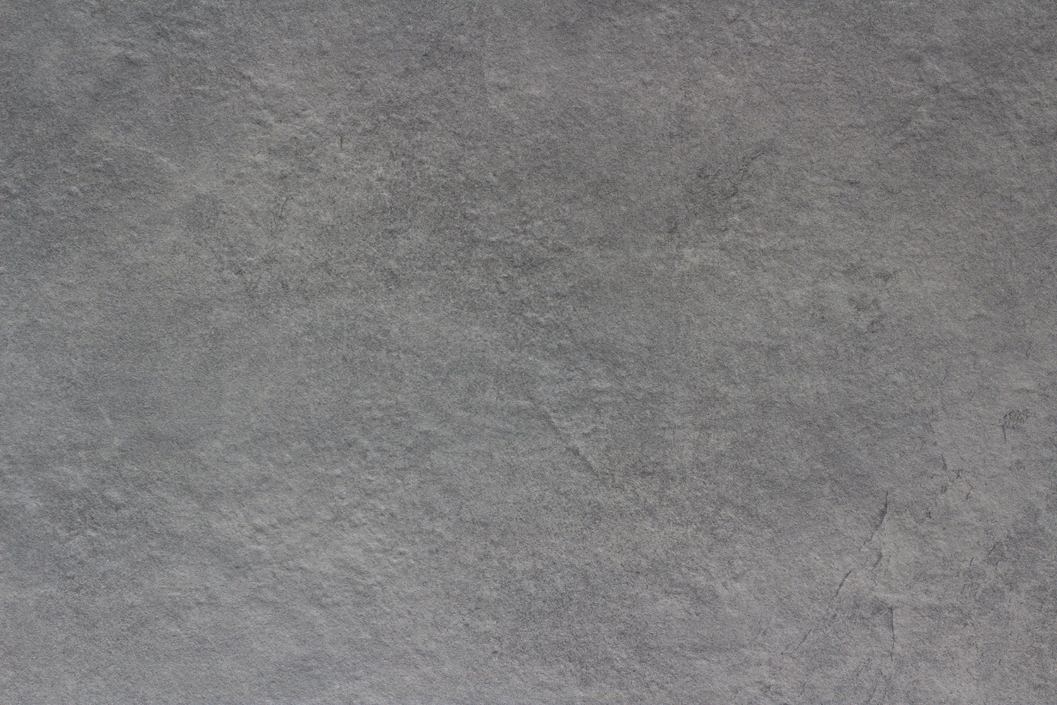 Rough, gray stone surface with subtle texture and natural variegation; appears slightly uneven and has a muted, matte finish—ideal as a slip-resistant tile for outdoor porcelain tile applications.