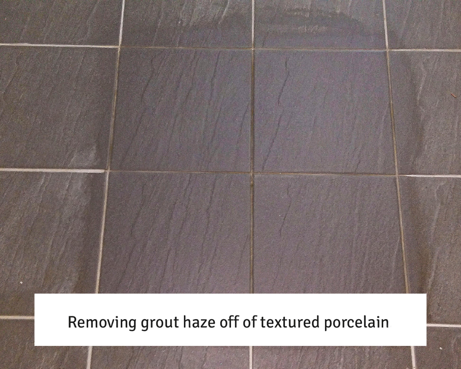 A close-up of dark textured porcelain tiles with visible grout haze. Text overlay reads: "Removing grout haze off of textured porcelain using a grout residue remover.