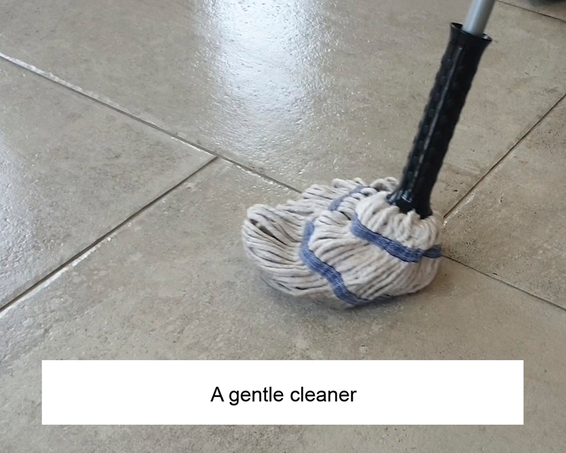 A mop with a black handle and white mop head is cleaning a shiny tiled floor. The image includes the caption, "A gentle cleaner for delicate surfaces.