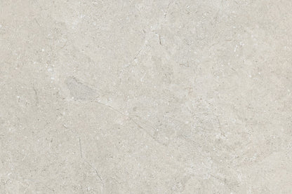 Light gray marble surface with subtle white and darker gray veining, this smooth texture mirrors the elegance of Lindeman Marfil Porcelain tiles—ideal for sleek countertops or as outdoor porcelain tiles with a natural stone look.