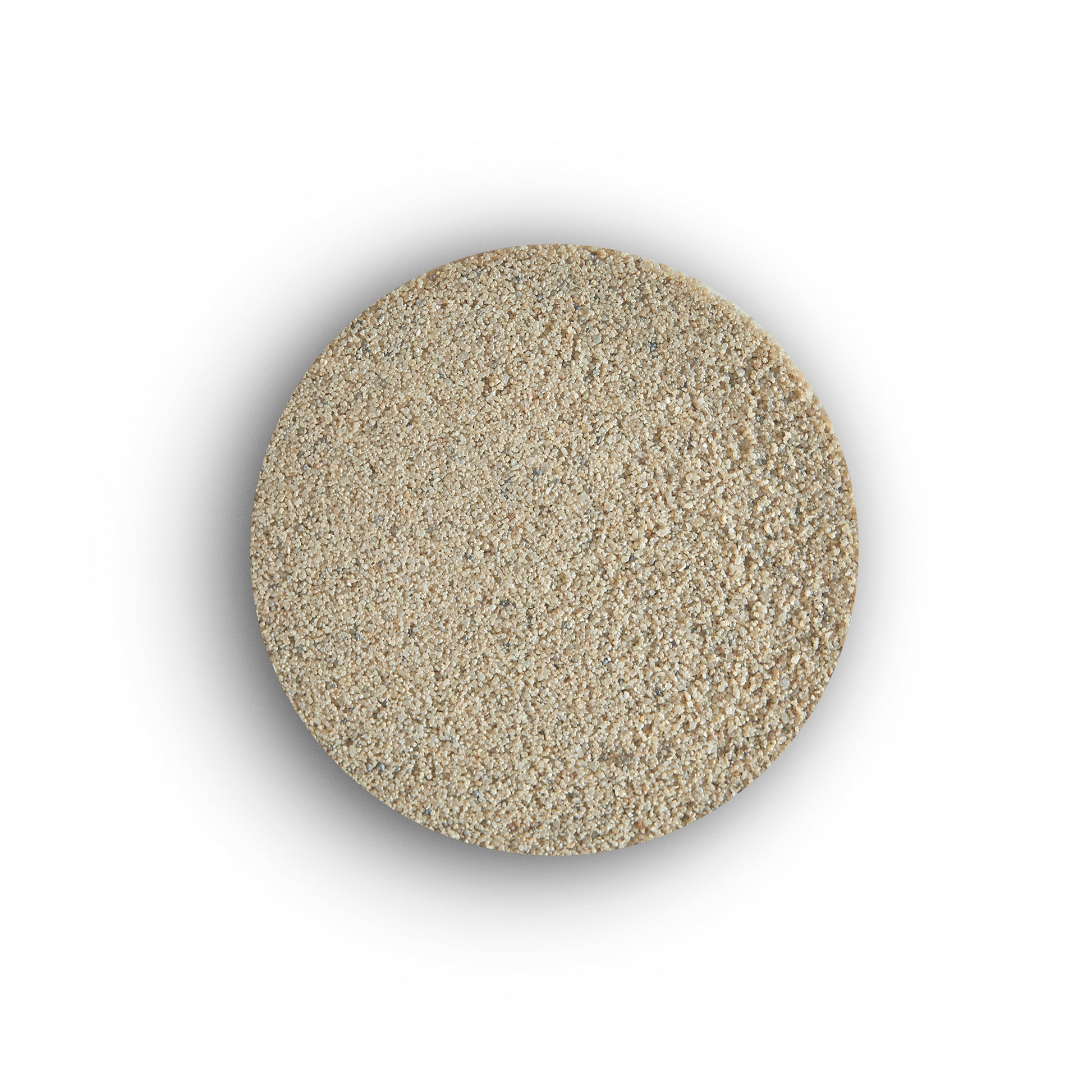 A round pile of light beige, granular instant dry yeast viewed from above on a white background, resembling the fine texture of porcelain tile grout.