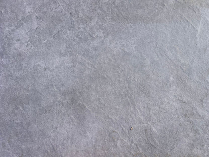 A close-up view of a smooth, gray stone surface with subtle texture and natural variations in color, reminiscent of Rasa Grigio Porcelain tiles—ideal for stylish, slip-resistant outdoor porcelain paving.